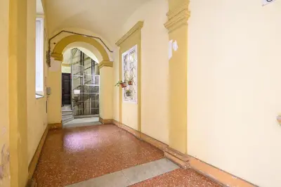 an empty hallway of a home with an archway at Gracchi Apartment Prati in Rome