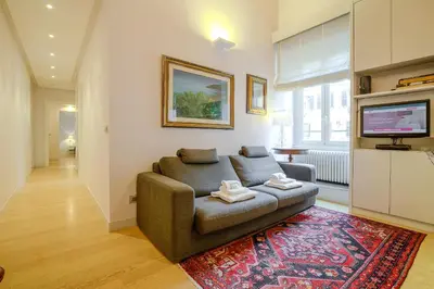 a living room with a couch and a television at Gracchi Apartment Prati in Rome