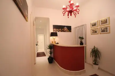 a lobby with a red counter in a room at Guesthouse Interno 7 Luxury Rooms in Rome