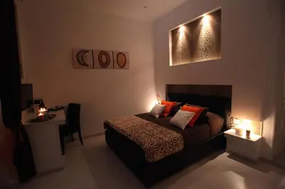 a bedroom with a bed and a table with a chair at Guesthouse Interno 7 Luxury Rooms in Rome