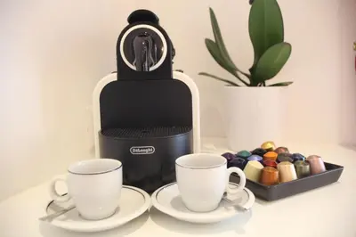 a coffee maker with two cups on a table at Guesthouse Interno 7 Luxury Rooms in Rome