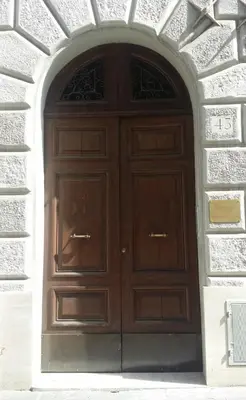 a large wooden door in a brick wall at Guesthouse Interno 7 Luxury Rooms in Rome