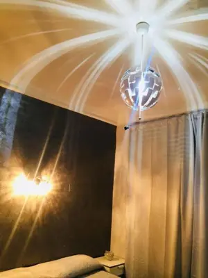 a bedroom with a chandelier and a curtain at Richbaby in Rome
