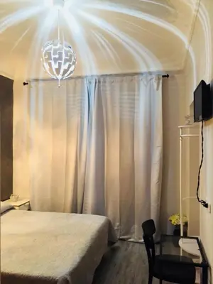 a bedroom with a bed and a chandelier at Richbaby in Rome