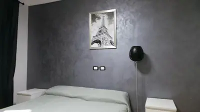 a bedroom with a bed and a picture of the eiffel tower at Richbaby in Rome
