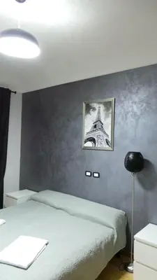 a bedroom with a bed and a picture of the eiffel tower at Richbaby in Rome