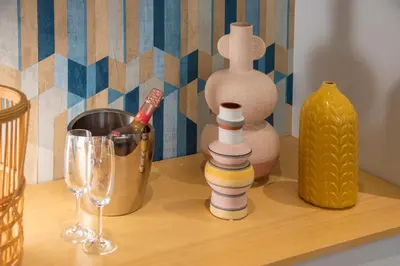 a table with wine glasses and a bottle of wine at La Grande Bellezza Guest House Rome in Rome