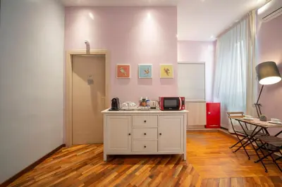 a room with a white cabinet and a table at La Grande Bellezza Guest House Rome in Rome