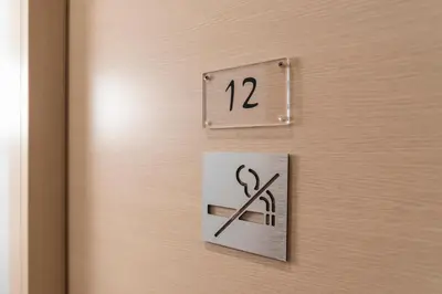a door with a pair of scissors on it at La Grande Bellezza Guest House Rome in Rome