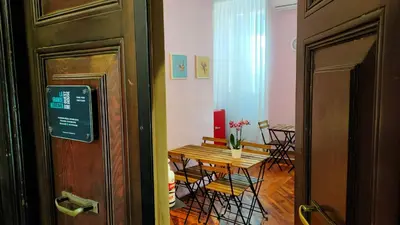 a room with a table and chairs and a table and a door at La Grande Bellezza Guest House Rome in Rome