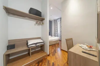 a room with a desk and a bed in a room at La Grande Bellezza Guest House Rome in Rome