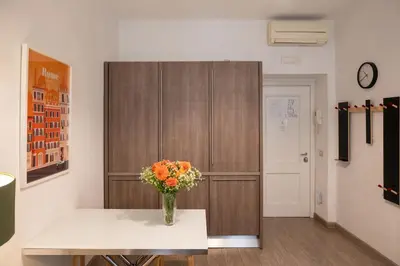 a vase of flowers sitting on a table in a room at Banchi Vecchi Stay Apt Suite Navona in Rome
