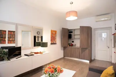 a living room with a desk with a computer in it at Banchi Vecchi Stay Apt Suite Navona in Rome