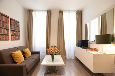 a living room with a couch and a tv at Banchi Vecchi Stay Apt Suite Navona in Rome