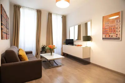 a living room with a couch and a tv at Banchi Vecchi Stay Apt Suite Navona in Rome