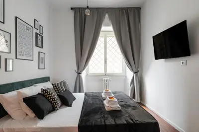 a living room with a bed and a window at Termini apartments in Rome