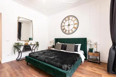 a bedroom with a bed and a large clock on the wall at Termini apartments in Rome