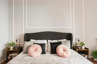 a bedroom with a bed with two pink pillows at Termini apartments in Rome