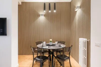 a dining room with a black table and chairs at THE FIFTH Properties Luxury Apartment near LUISS Rome Viale Libia in Rome