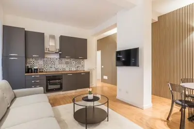 a living room with a couch and a table at THE FIFTH Properties Luxury Apartment near LUISS Rome Viale Libia in Rome