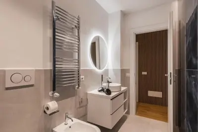 a white bathroom with a sink and a mirror at THE FIFTH Properties Luxury Apartment near LUISS Rome Viale Libia in Rome