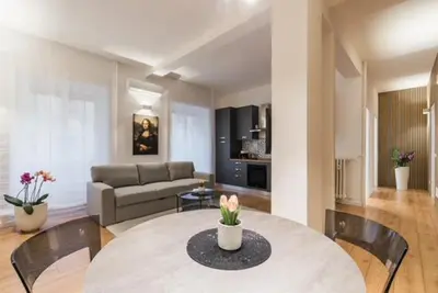 a living room with a table and a couch at THE FIFTH Properties Luxury Apartment near LUISS Rome Viale Libia in Rome