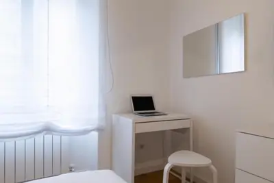a white room with a table with a laptop on it at THE FIFTH Properties Luxury Apartment near LUISS Rome Viale Libia in Rome