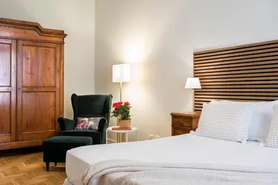 a bedroom with a bed and a chair at AV Domus Propaganda in Rome