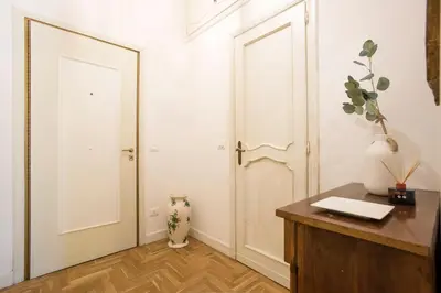 a room with two white doors and a desk at AV Domus Propaganda in Rome