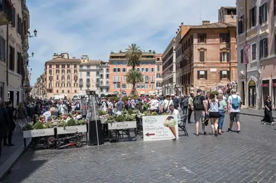 a crowd of people walking down a city street at AV Domus Propaganda in Rome