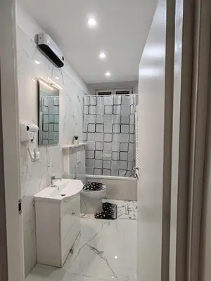 a white bathroom with a sink and a toilet at Dolce Vita Romana in Rome