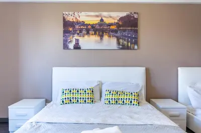 a bedroom with a bed and a painting on the wall at Cipro Vatican House in Rome