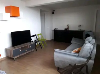 a living room with a couch and a tv at Stanza in superattico, terrazzato, luminoso, accogliente, bagno privato in Rome