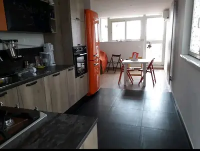 a kitchen and dining room with a table and chairs at Stanza in superattico, terrazzato, luminoso, accogliente, bagno privato in Rome