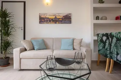 a living room with a couch and a glass table at Appartamento San Pietro-Vaticano in Rome