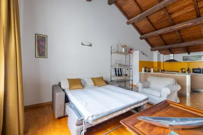 a room with a bed and a couch and a table at Baccina 45 - Cozy Quiet Apt in Rome