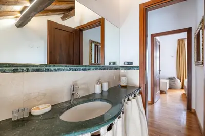 a bathroom with a sink and a mirror at Baccina 45 - Cozy Quiet Apt in Rome