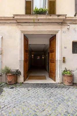 an entrance to a building with wooden doors at Baccina 45 - Cozy Quiet Apt in Rome