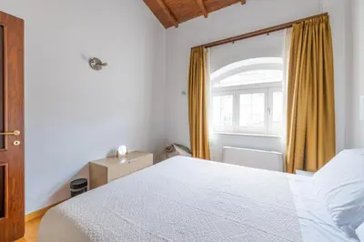 a bedroom with a white bed and a window at Baccina 45 - Cozy Quiet Apt in Rome