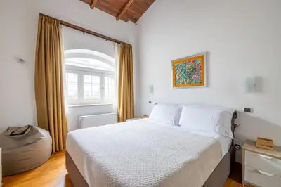 a bedroom with a white bed and a window at Baccina 45 - Cozy Quiet Apt in Rome
