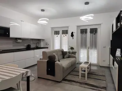 a living room with a couch and a kitchen at ROMAN'S HOUSE in Rome