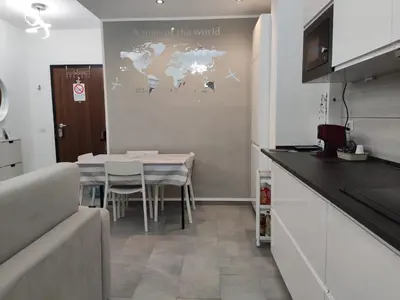 a kitchen with a table and a world map on the wall at ROMAN'S HOUSE in Rome