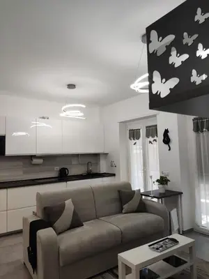 a living room with a couch and a kitchen at ROMAN'S HOUSE in Rome