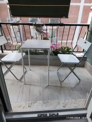 a white table and two chairs on a balcony at ROMAN'S HOUSE in Rome