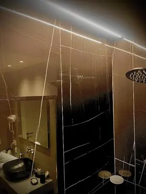 a bathroom with a shower with spider webs on the wall at L'Isola che non c'è in Rome