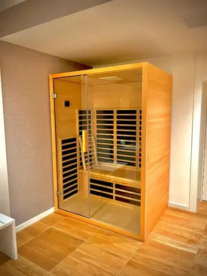 a glass cabinet in a room with wooden floors at L'Isola che non c'è in Rome
