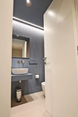 a bathroom with a sink and a toilet and a mirror at L'Isola che non c'è in Rome