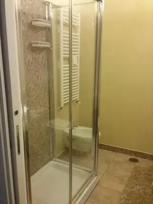 a glass shower in a bathroom with a toilet at Orso Luxury Apartment in Rome