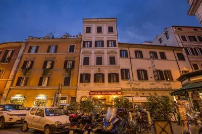 a city street with cars and motorcycles in front of buildings at Orso Luxury Apartment in Rome