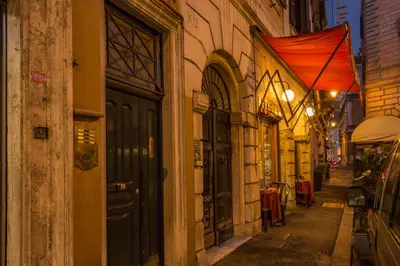 an alley way with a building with a black door at Orso Luxury Apartment in Rome